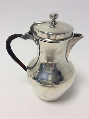Lot 157 - Victorian silver hot water pot of baluster form with angular spout, hinged cover and leather covered loop handle (London 1880), all at approximately 16oz, approximately 19cm in height