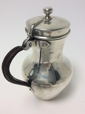 Lot 157 - Victorian silver hot water pot of baluster form with angular spout, hinged cover and leather covered loop handle (London 1880), all at approximately 16oz, approximately 19cm in height
