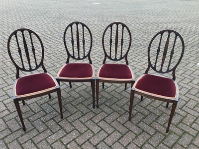 Lot 100 - Four Edwardian mahogany dining chairs with red upholstered seats
