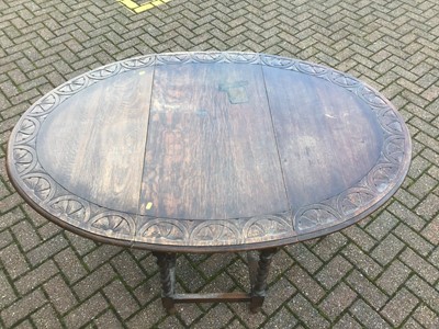Lot 74 - Carved oak oval drop leaf table