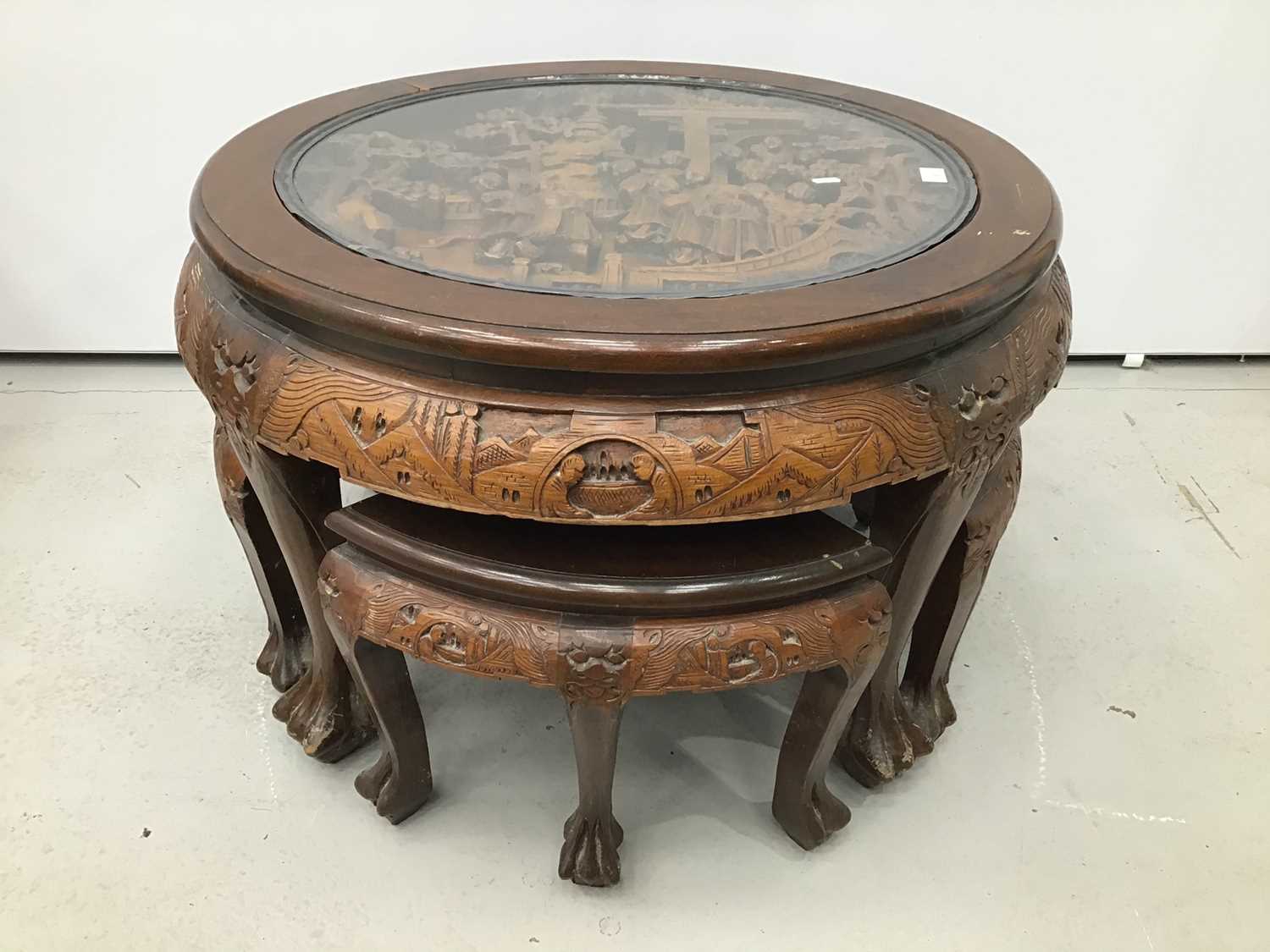 Lot 8 - Chinese circular carved coffee table with integral nest of tables