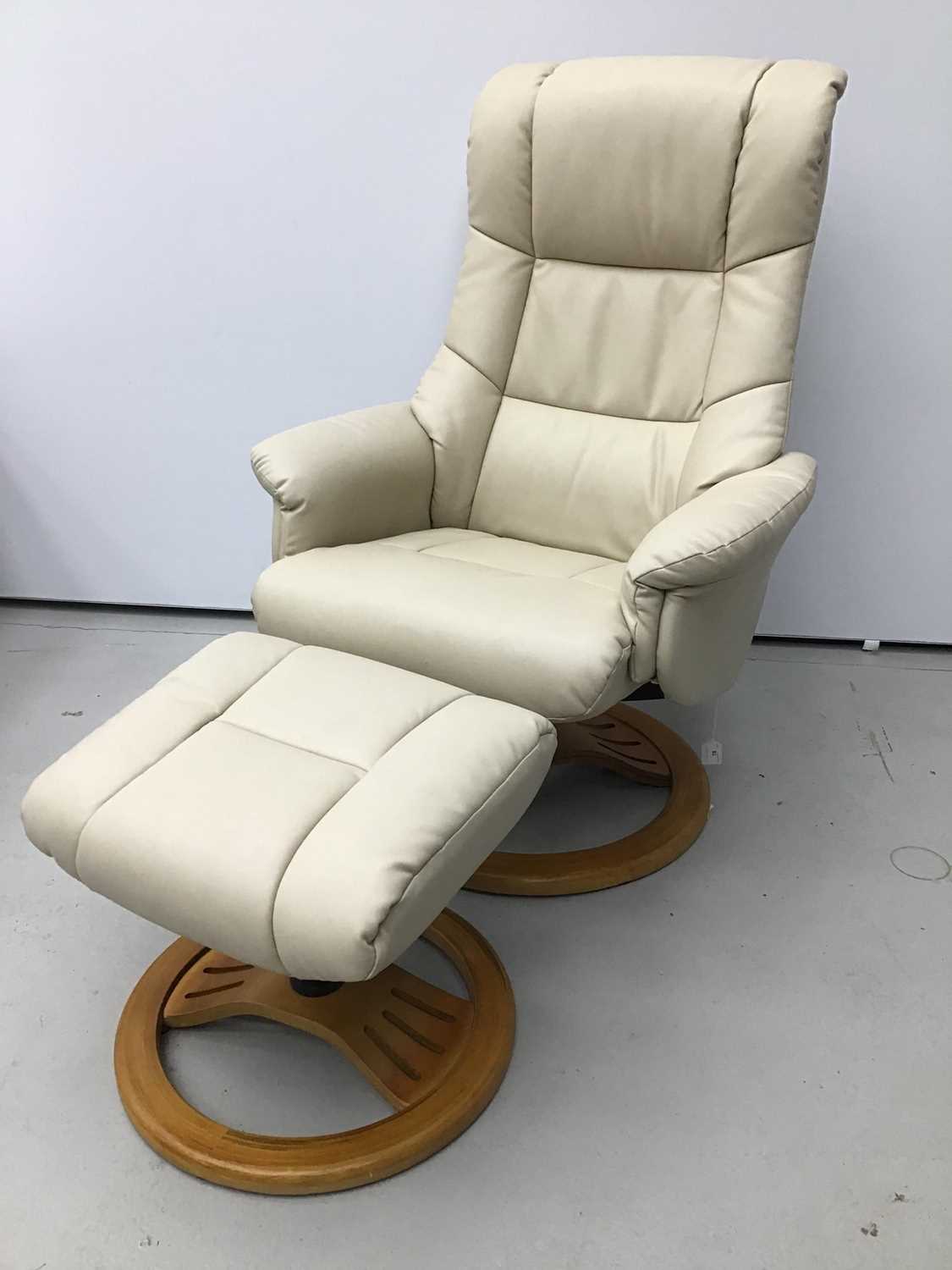 Lot 76 - Cream leather easy chair and footstool