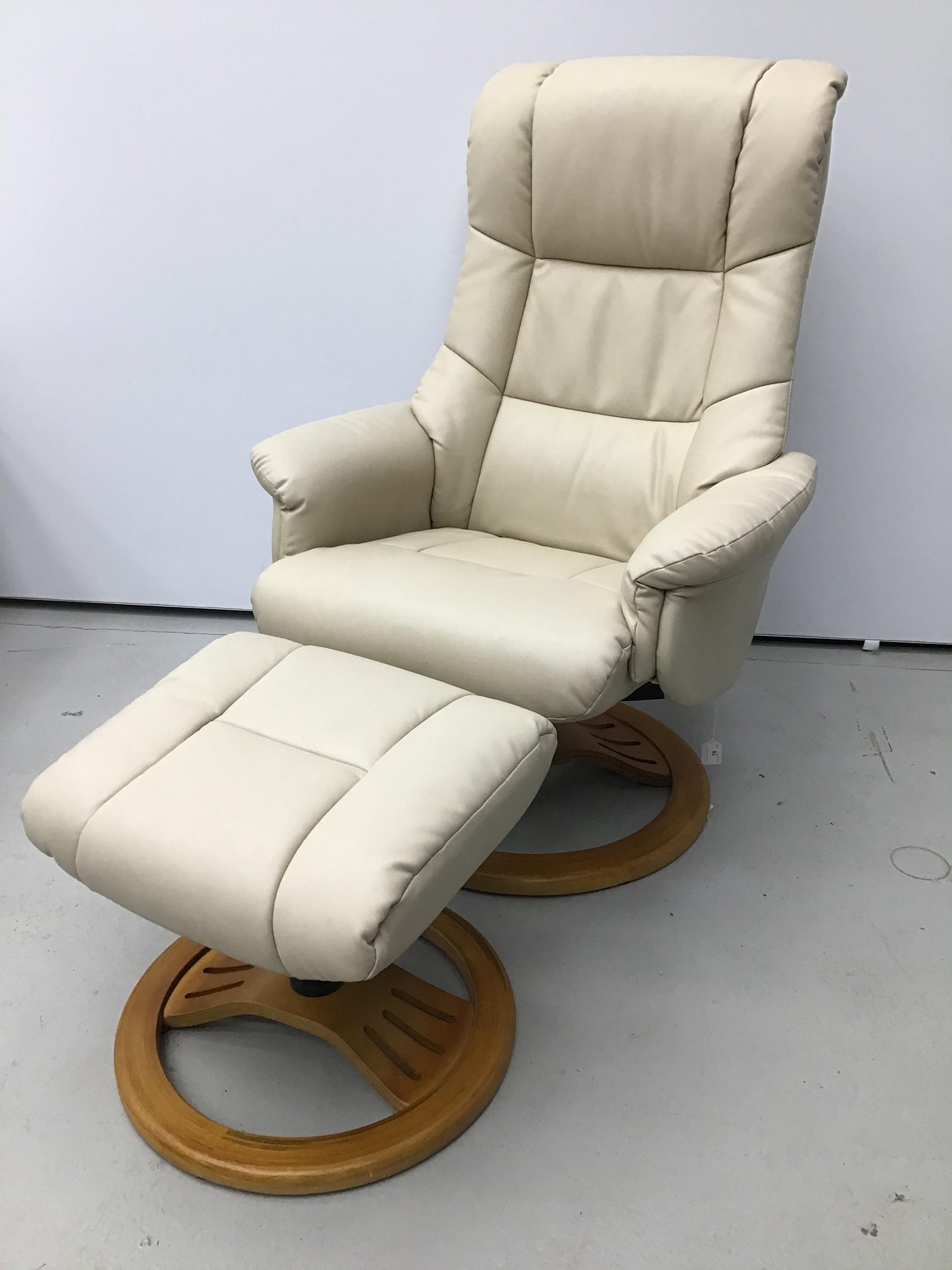 Lot 76 Cream leather easy chair and footstool