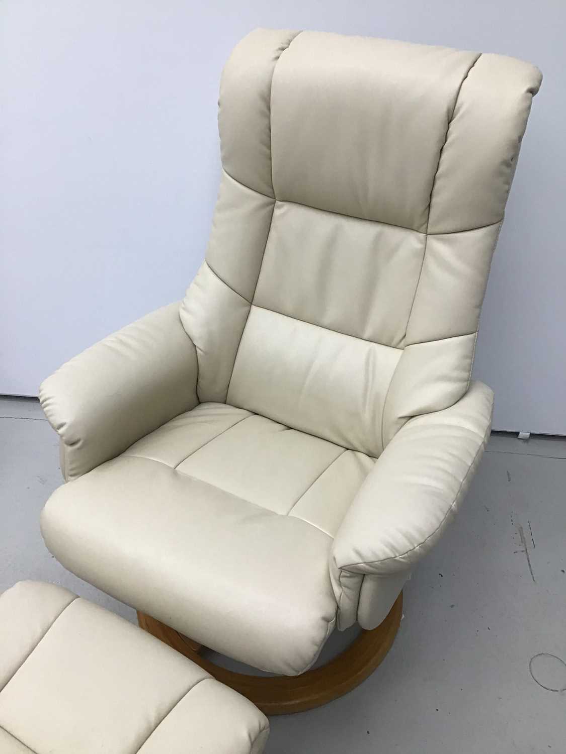 Lot 76 Cream leather easy chair and footstool