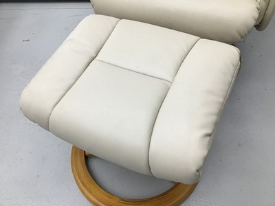 Lot 76 - Cream leather easy chair and footstool