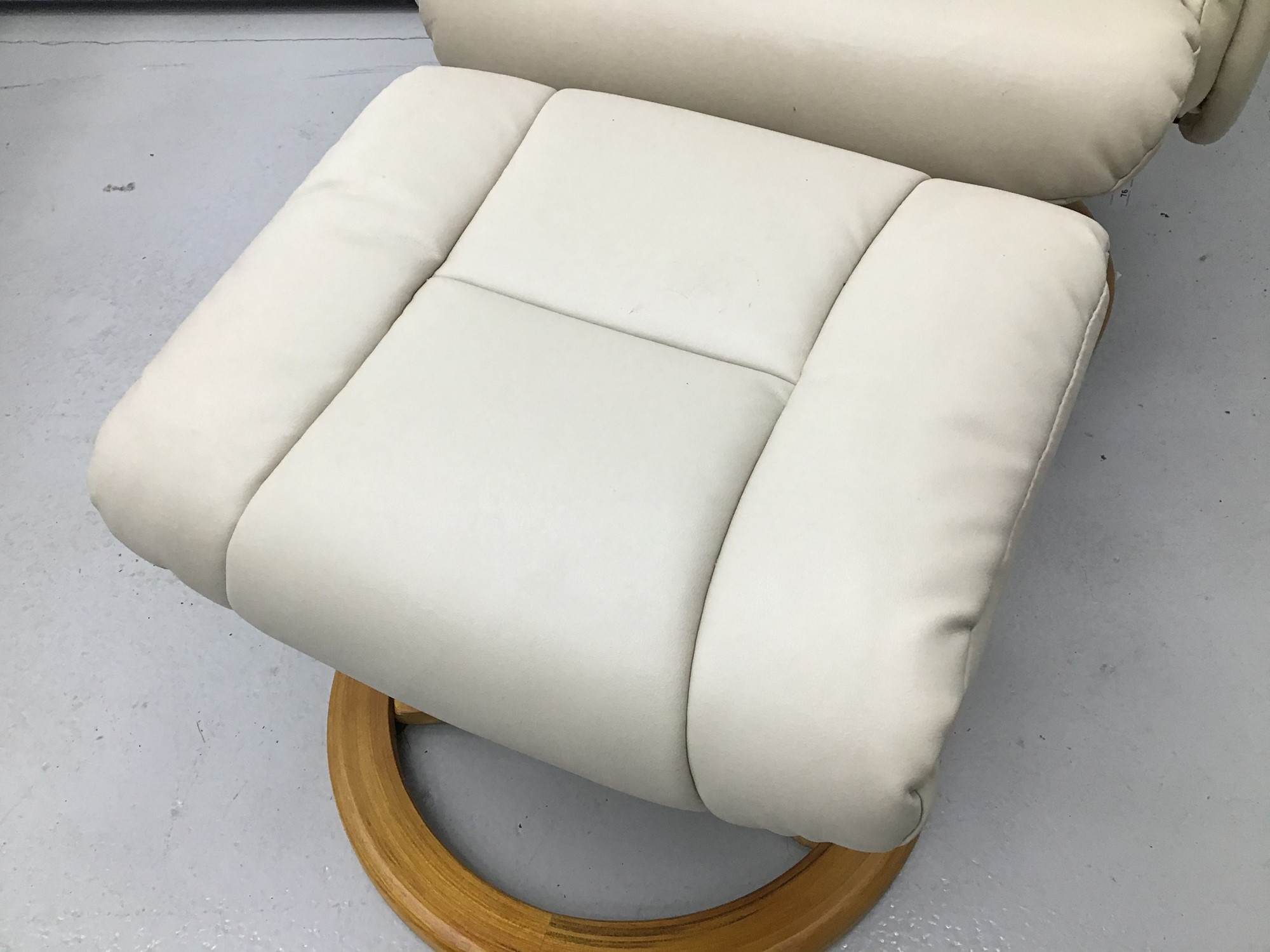 Lot 76 Cream leather easy chair and footstool