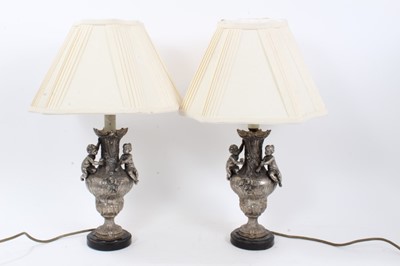 Lot 692 - Pair of silvered table lamps with putti
