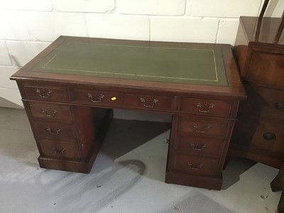 Lot 95 - An early 20th century mahogany twin pedestal desk, with tooled green leather inset top and nine drawers about the kneehole on plinth bases and castors. 121cm wide x 65cm deep x 72cm high