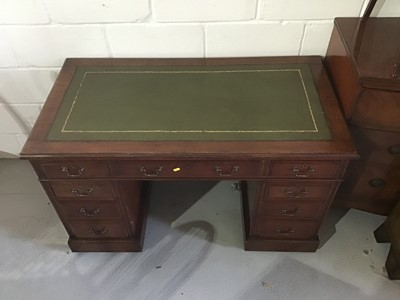 Lot 95 - An early 20th century mahogany twin pedestal desk, with tooled green leather inset top and nine drawers about the kneehole on plinth bases and castors. 121cm wide x 65cm deep x 72cm high