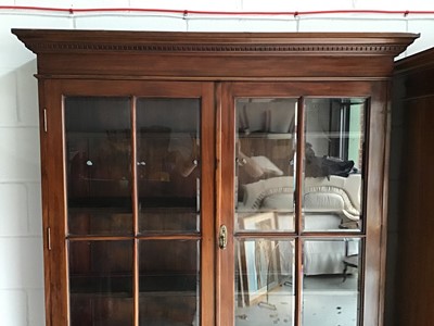 Lot 134 - Good quality Edwardian mahogany two-height bookcase with moulded dentil cornice, the interior with wooden shelves enclosed by bevelled astragal glazed doors with two drawers and panelled cupboards...