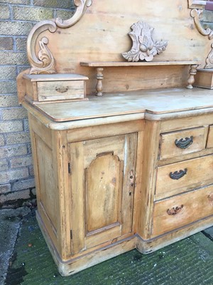 Lot 202 - Pine sideboard, the arched gallery back with carved cresting and short drawers, breakfront base with central drawers and flaking cupboards on plinth base, 148cm wide x 53cm deep x 144cm high