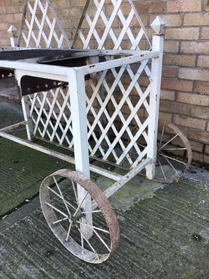 Lot 204 - Bespoke made garden barbecue, white painted with  lattice back and central grill on square section framework with end wheel, 124cm wide x 63cm deep x 123cm high