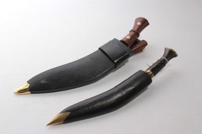 Lot 926 - Two modern Gurka Kukri's in leather sheaths, larger blade 30cm in length, smaller blade 26.5cm in length (2)