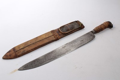 Lot 931 - Old bush knife with wicker bound wooden grip, in leather sheath, together with an African dagger in leather sheath (2)