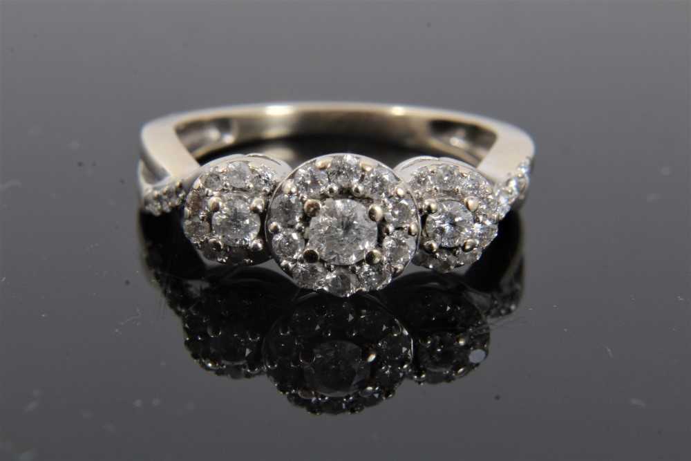 Lot 292 - Diamond triple cluster ring in 18ct white