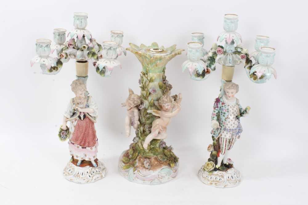 Lot 111 - Pair of Continental porcelain figural candlesticks, similar table centre .