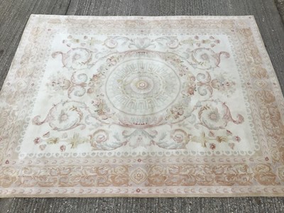 Lot 1017 - Wool pile rug with classical medallion and scroll foliate ornament