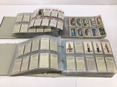 Lot 724 - Cigarette cards selection of sets and part sets in five files including Players Cricketers 1938, Ogdens Sea Adventure, Wills Ships Badges, Military Motors, Fish and Bait, Aviation and others