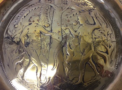 Lot 443 - 17th century German brass alms dish, with Adam and Eve embossed convex roundel and broad geometric border, 35cm diameter 
Provenance: Estate of the Late Jane Sumner