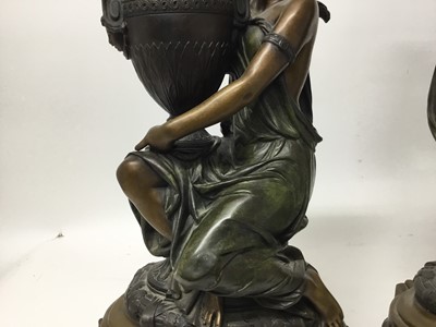 Lot 384 - Carrier-Belleuse (1824-1877) - Impressive pair of bronze and patinated bronze figural urns, each modelled as a Classical maiden cradling an Etruscan style vase raised on stepped shaped plinth with...