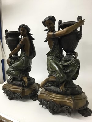 Lot 384 - Carrier-Belleuse (1824-1877) - Impressive pair of bronze and patinated bronze figural urns, each modelled as a Classical maiden cradling an Etruscan style vase raised on stepped shaped plinth with...