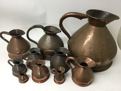 Lot 405 - Matched set of nine antique brass flagon measures