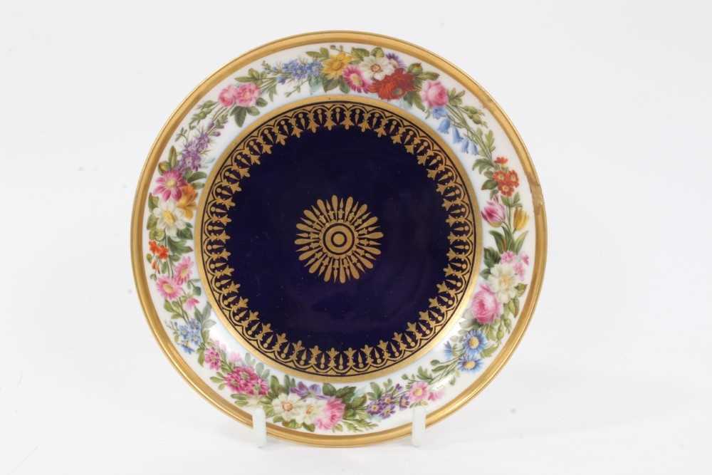 Lot 44 - Sevres dish, finely painted with flowers around the edge, the centre with gilt patterns on a bleu lapis ground, printed and inscribed marks to base, 15.25cm diameter