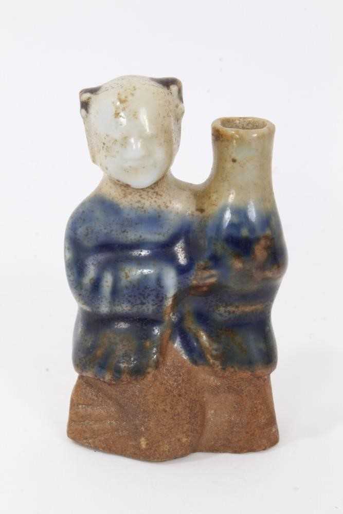 Lot 48 - Chinese Qing biscuit porcelain water dropper, in the form of a boy holding a vase, the bottom unglazed and the top glazed in two tones of blue, 7.5cm height