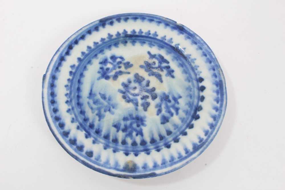 Lot 50 - Persian Qajar tin glazed pottery dish, painted in blue with a foliate pattern, 17cm diameter