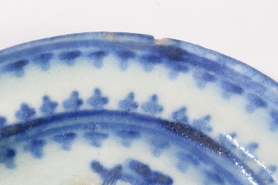 Lot 50 - Persian Qajar tin glazed pottery dish, painted in blue with a foliate pattern, 17cm diameter