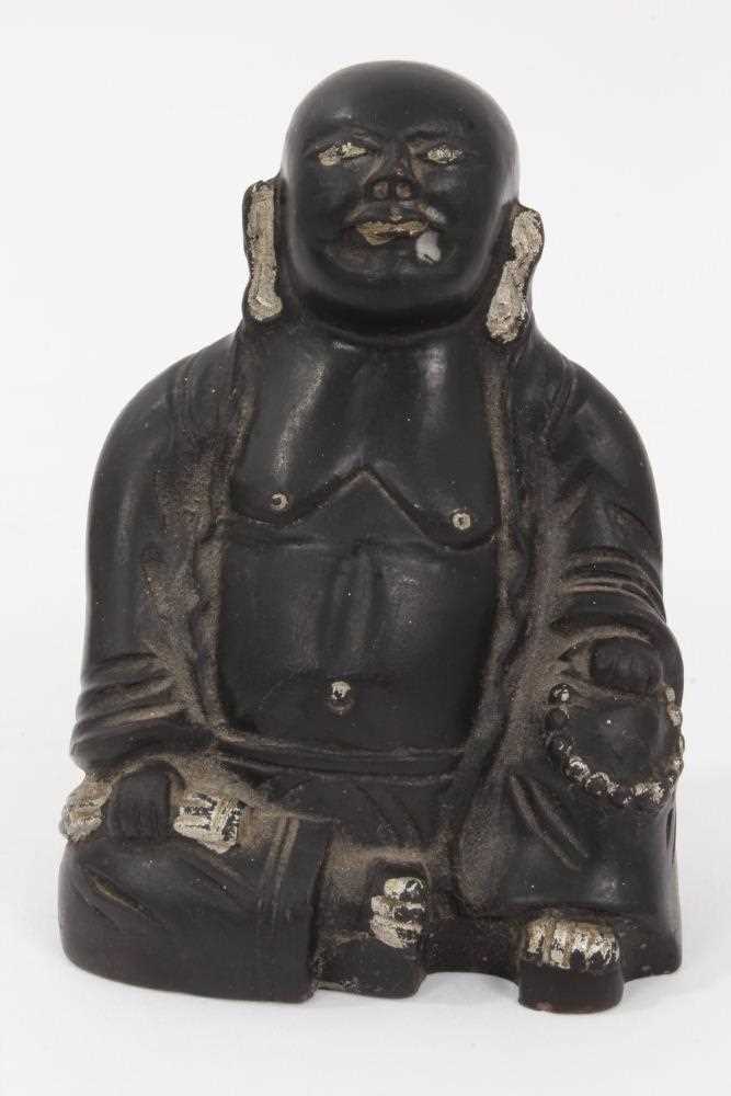 Lot 60 - Chinese earthenware figure of Buddha, painted black with silver highlights, marked to the base, 9cm height