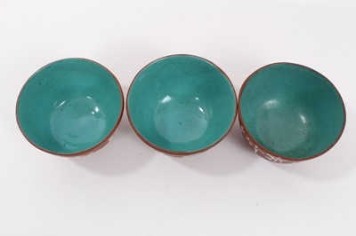 Lot 61 - Set of nine Chinese Yixing pottery tea bowls, painted with calligraphy, enamelled blue inside and on the bases, each approximately 7cm diameter x 4.5cm height