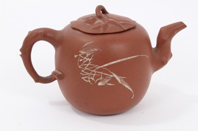 Lot 64 - Chinese Yixing teapot, leaf and branch form handle, spout and lid, the body decorated with calligraphy on one side and a foliate motif on the other, seal mark inside the lid, 15.5cm length x 10cm h...