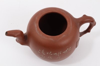Lot 64 - Chinese Yixing teapot, leaf and branch form handle, spout and lid, the body decorated with calligraphy on one side and a foliate motif on the other, seal mark inside the lid, 15.5cm length x 10cm h...