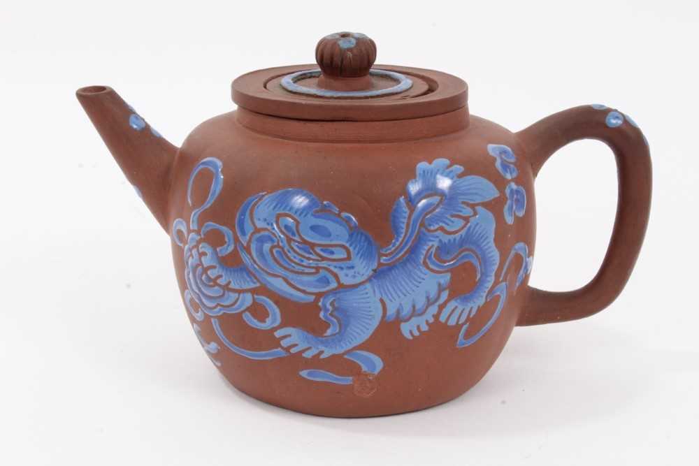 Lot 67 - Chinese Yixing teapot and strainer, enamelled in blue with a foo dog, and auspicious symbols verso, seal mark to base, 12cm height x 20cm length