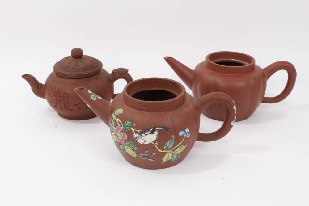 Lot 69 - Three Chinese Yixing teapots, including one enamelled with birds and flowers, another of plain melon form, and another with calligraphy, all with seal marks, between 19cm and 23cm length