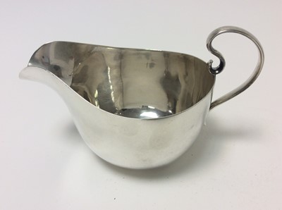Lot 155 - George VI silver sauce boat of conventional form (Birmingham 1941), together with another silver sauce boat (Sheffield 1922) and a silver cream jug (Birmingham 1912), first sauce boat 14cm in lengt...