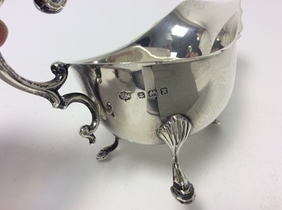 Lot 155 - George VI silver sauce boat of conventional form (Birmingham 1941), together with another silver sauce boat (Sheffield 1922) and a silver cream jug (Birmingham 1912), first sauce boat 14cm in lengt...