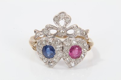 Lot 269 - Victorian style diamond, ruby and sapphire twin-heart ring with a mixed cut ruby and blue sapphire surrounded by a border of old cut diamonds in silver collet setting, surmounted by a diamond ribbo...
