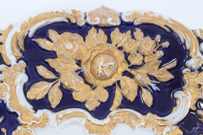 Lot 78 - Meissen gilt-highlighted cobalt blue dish, decorated with flowers in relief, crossed swords mark to base, 30cm diameter