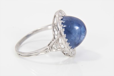 Lot 319 - Edwardian style sapphire and diamond cluster ring with an oval cabochon blue sapphire weighing approximately 8.49cts surrounded by a border of old cut diamonds in millegrain setting with pierced ga...