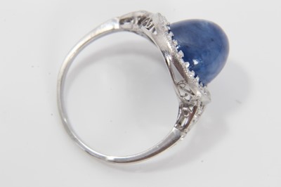 Lot 319 - Edwardian style sapphire and diamond cluster ring with an oval cabochon blue sapphire weighing approximately 8.49cts surrounded by a border of old cut diamonds in millegrain setting with pierced ga...