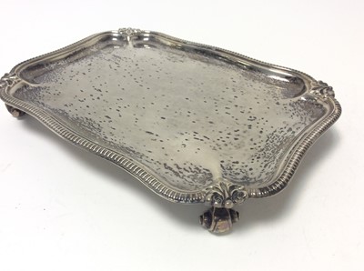 Lot 183 - George V silver waiter of rectangular form with gadrooned and scroll borders, raised on four scroll feet, (Sheffield 1926), maker Harrison Brothers & Howson, all at approximately 13oz, 20cm in leng...