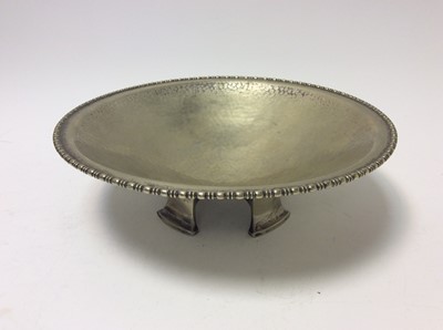 Lot 138 - Early 20th Century Arts & Crafts Silver Plated bowl with planished decoration and egg and dart borders, raised on four splayed feet, with marks to base for John Round & Sons Ltd, 26cm in diameter