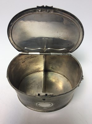 Lot 137 - Victorian silver plated teacaddy of oval form with engine turned decoration, twin lion mask handles, beaded foot and top rims and flush fitting hinged cover, 15.5cm in length