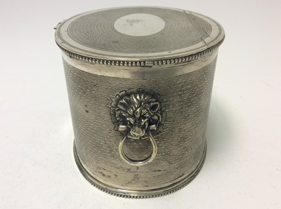 Lot 137 - Victorian silver plated teacaddy of oval form with engine turned decoration, twin lion mask handles, beaded foot and top rims and flush fitting hinged cover, 15.5cm in length