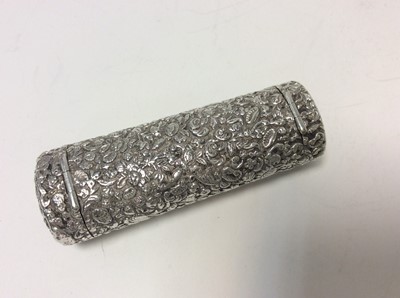 Lot 133 - Late 19th century Continental silver combination vesta case and pill box of oval cylindrical form with chased floral and scroll decoration and hinged covers, 7.1cm in overall length