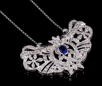 Lot 244 - Art Deco style sapphire and diamond pendant necklace with an openwork plaque with a central oval mixed cut blue sapphire weighing approximately 0.50cts surrounded by floral scrolls in 14ct white go...