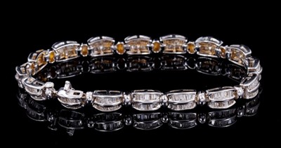 Lot 250 - Diamond bracelet with articulated links with baguette cut diamonds in 14ct white gold channel setting, estimated total diamond weight approximately 4cts. Length approximately 17.5cm