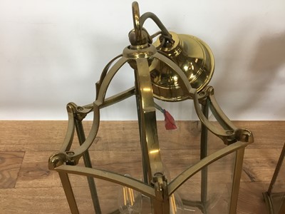 Lot 822 - Set of three Georgian style brass hanging hall lanterns, each of hexagonal form with bowed glass housing three lights, total height 41cm